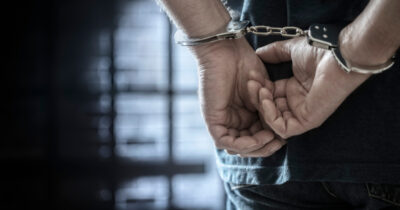 Arrested man in handcuffs. Credit: Shutterstock
