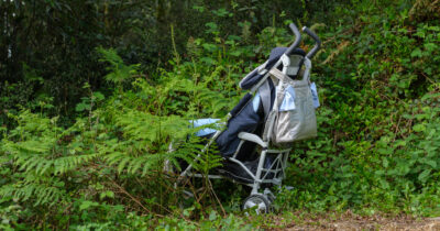 Baby stroller abandoned in woods. Credit: Shutterstock
