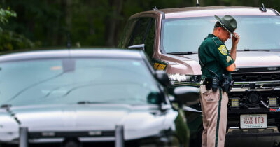 State troopers arrive at the Long family home. Credit / Getty Images