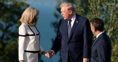 Brigitte Macron shakes hands with Donald Trump. Credit / Getty Images