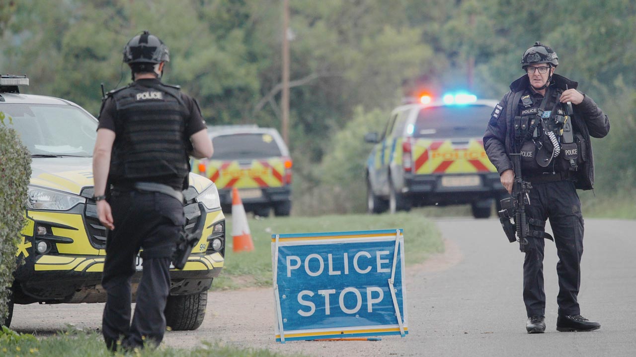 Police at a road block on the road to RAF Fairford after major incident has been declared, with armed police manning a cordon near the village of Whelford in Gloucestershire, near RAF Fairford which is used by the United States Air Force (USAF).
