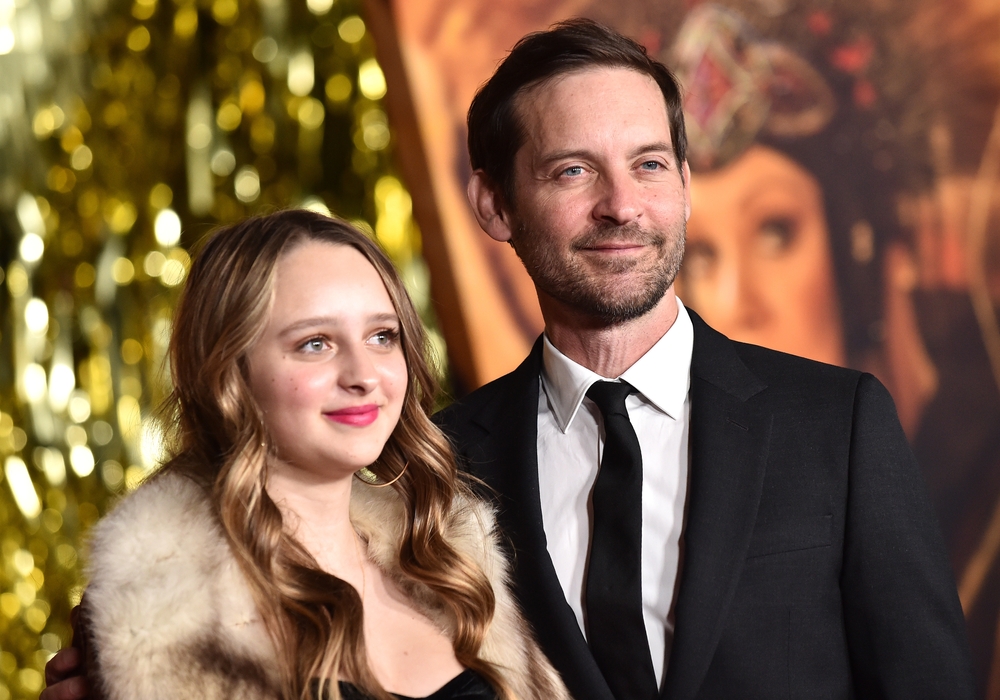 Tobey Maguire stoi w garniturze obok młodej kobiety