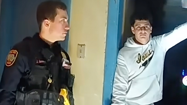 policjant i mężczyzna w białej bluzie